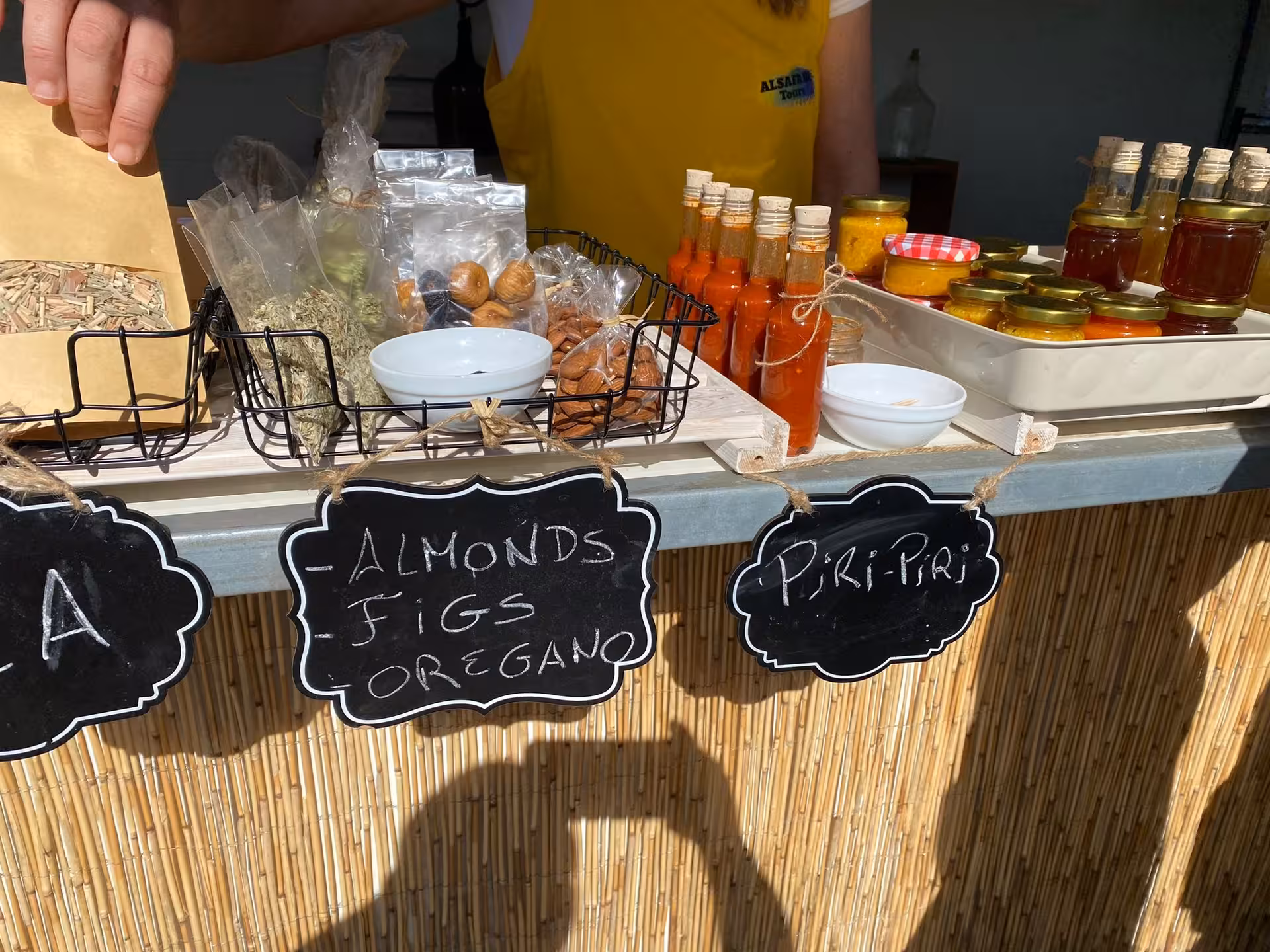 Local market stall with Algarve almonds, figs, oregano and piri-piri sauces, perfect stop on a sunset sparkling wine tour