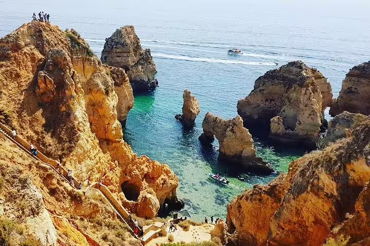 Scenic cliffs and turquoise waters of Ponta da Piedade on Algarve private tour with boat ride from Lisbon.