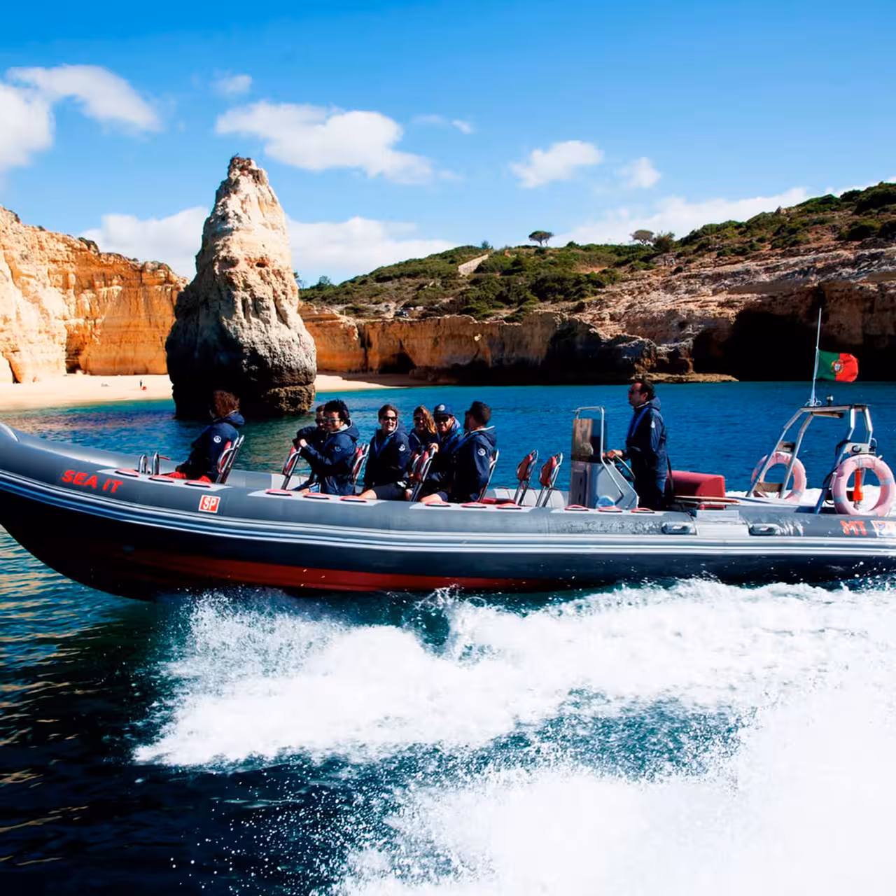 RIB speedboat cruising Algarve coast past sea stacks and caves on Caves and Dolphins wildlife tour