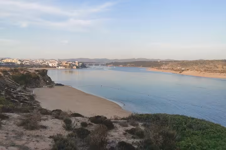 Wide view of Algarve river estuary and sandy beach, ideal sightseeing stop on private transfer to Lisbon