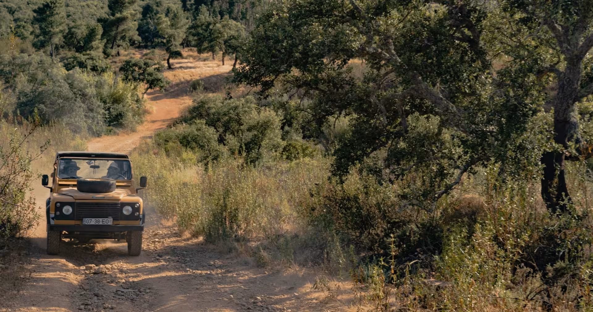 4x4 jeep driving along a dusty off-road trail through Algarve countryside during a guided half-day private safari
