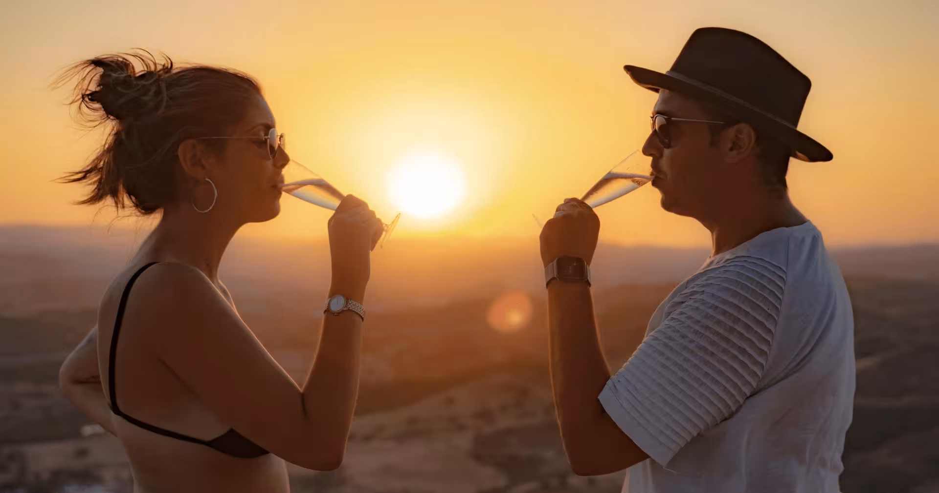 Couple sipping champagne at golden Algarve sunset on a private jeep safari tour in Portugal