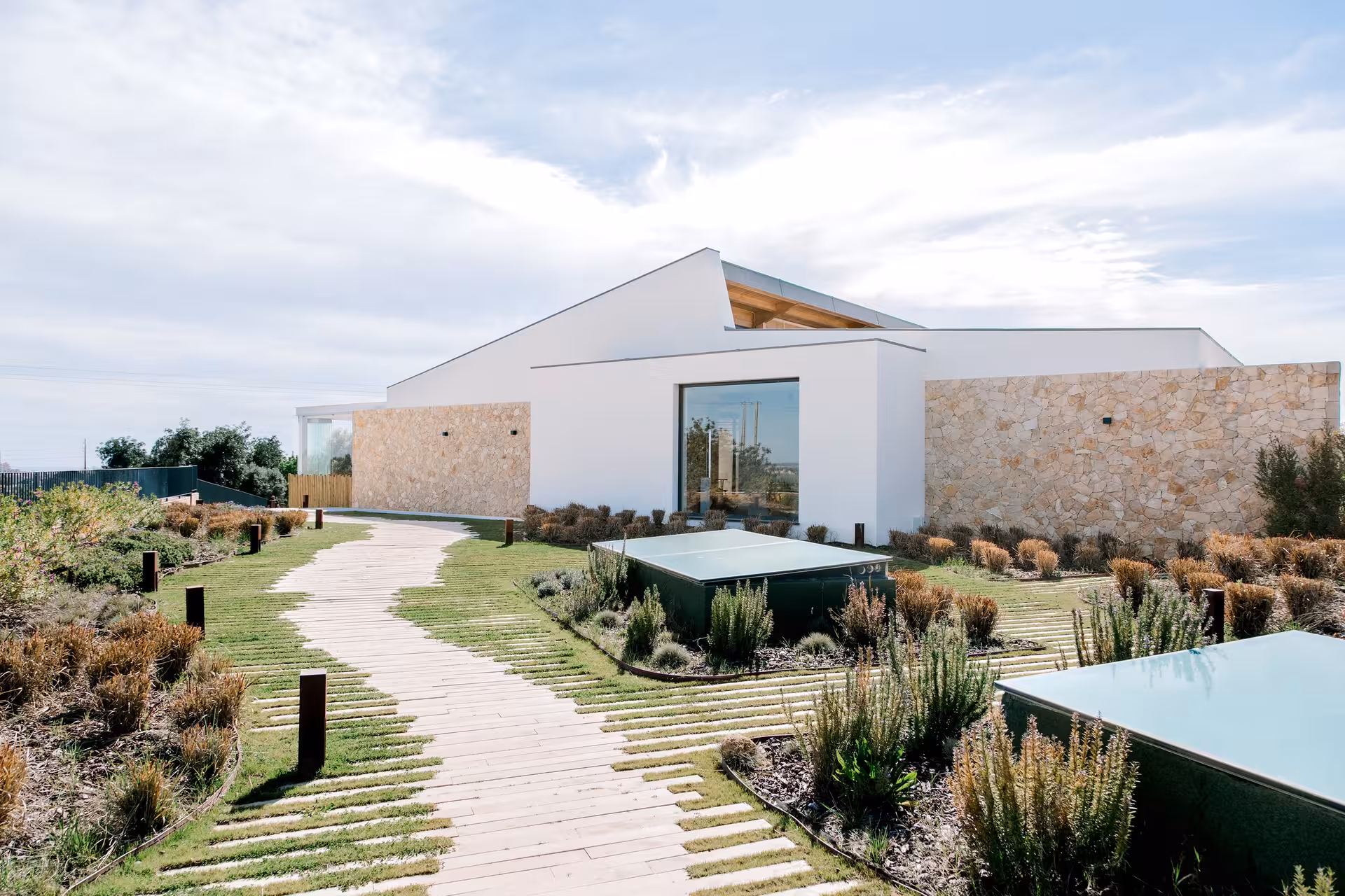 Modern countryside winery with minimalist white architecture and landscaped garden path for Algarve half day wine tasting tour
