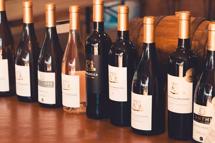A selection of Algarve wines displayed on a wooden table, featured in the Full-Day Tour from Albufeira.