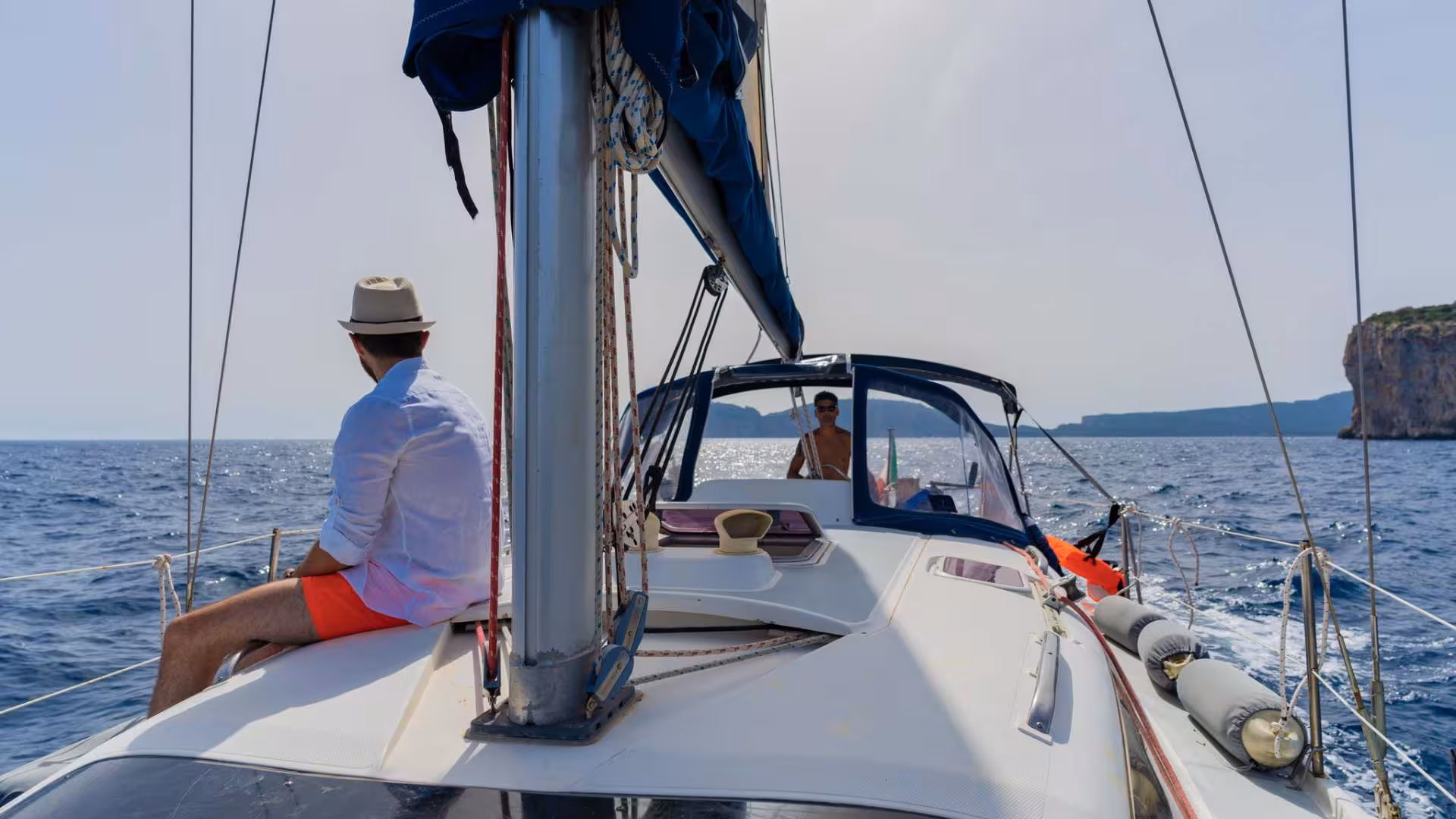 Exploring Porto Conte Park by sailboat with beautiful views of the sea and rugged cliffs near Alghero.