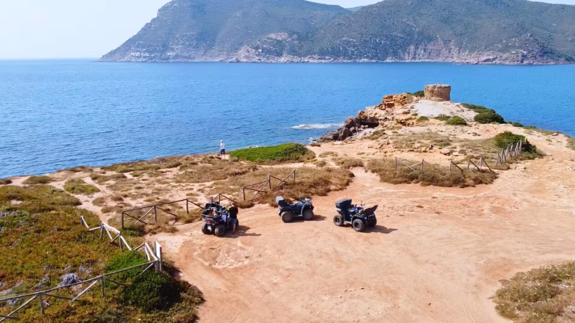 Quads parked near Alghero's coastal cliffs, offering breathtaking views of the sea and rugged terrain.