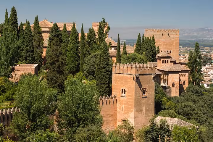 Explore the historic Alhambra with stunning architecture surrounded by lush greenery on the Andalucia tour from Costa del Sol.