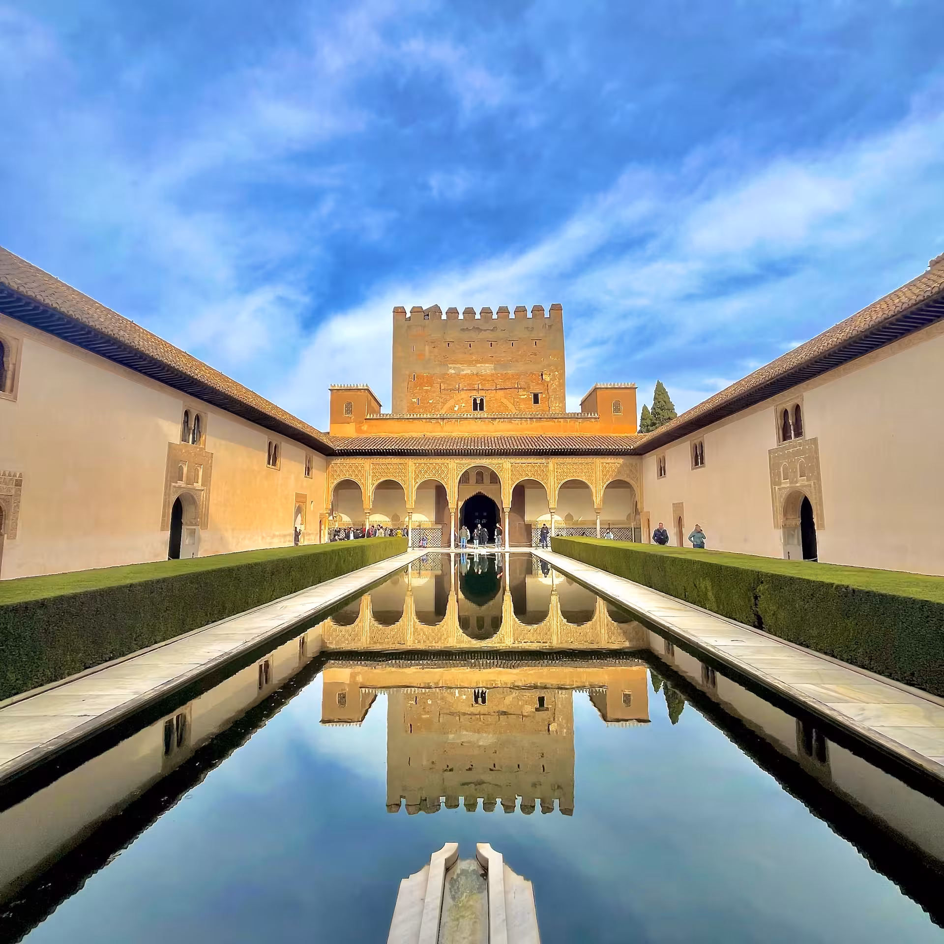 Alhambra Court of the Myrtles reflecting pool and Comares Tower, highlight of Encantos Locales + Alhambra guided visit