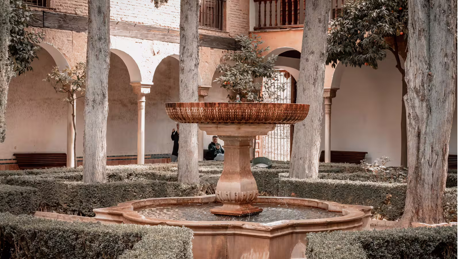 Alhambra courtyard fountain and orange trees on a private walking tour with expert guide in Granada, Spain