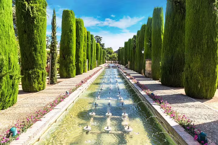 Lush gardens and serene water features at Alhambra, ideal for cruise passengers exploring Granada from Malaga Port.