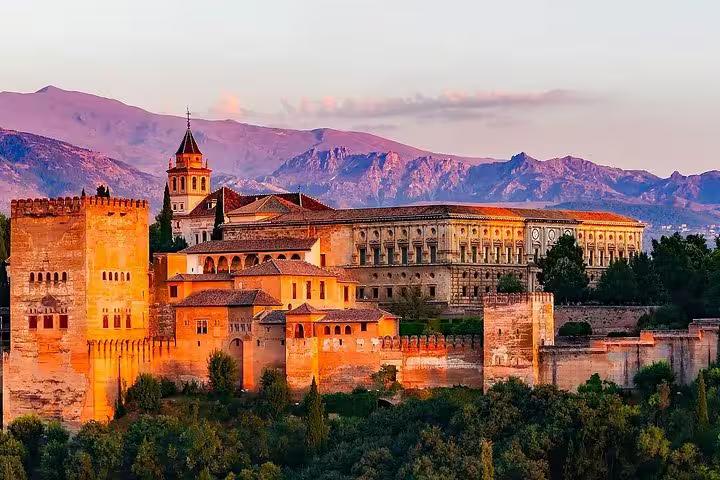 Stunning view of the Alhambra in Granada at sunset, highlighting the historic architecture and scenic backdrop for tours.