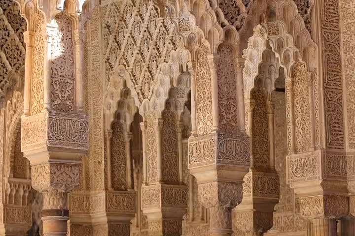 Intricate Moorish arches and carvings in Alhambra, a highlight of the 7-day Andalusia and Madrid tour from Lisbon.