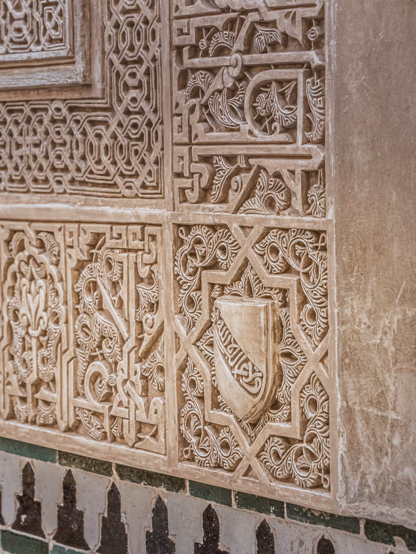 Intricate Islamic carvings adorn the walls of the Alhambra's Nasrid Palaces, showcasing exquisite Moorish artistry.