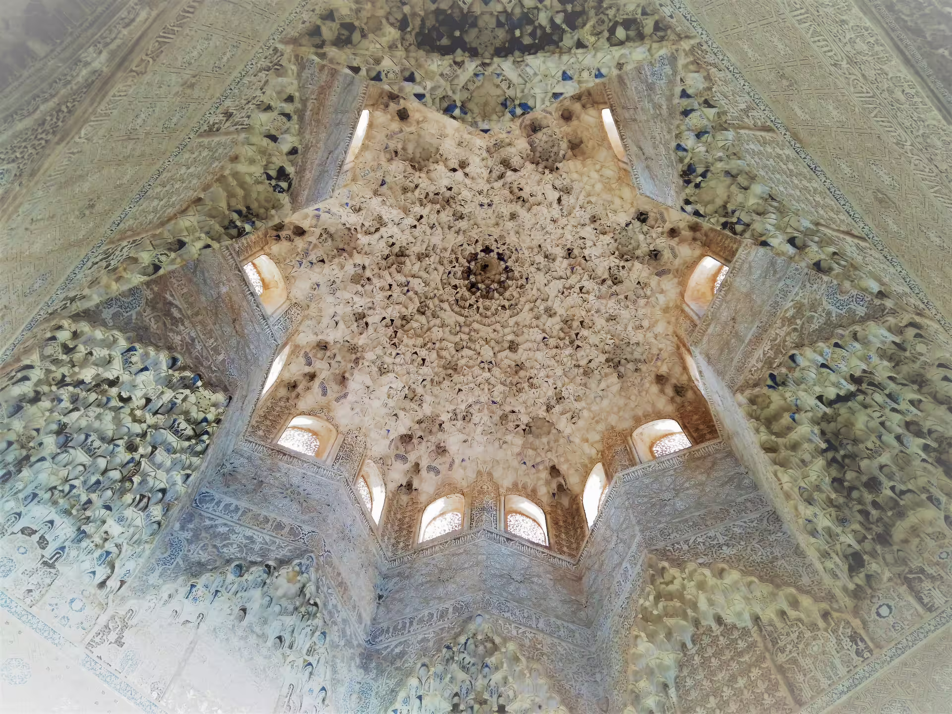 Intricate muqarnas dome ceiling inside the Alhambra Nasrid Palaces, Granada, on a private guided tour
