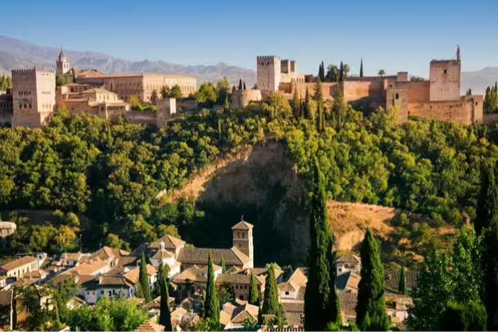 Scenic view of Alhambra Palace in Granada surrounded by lush greenery, ideal for cruise passengers touring from Malaga Port.