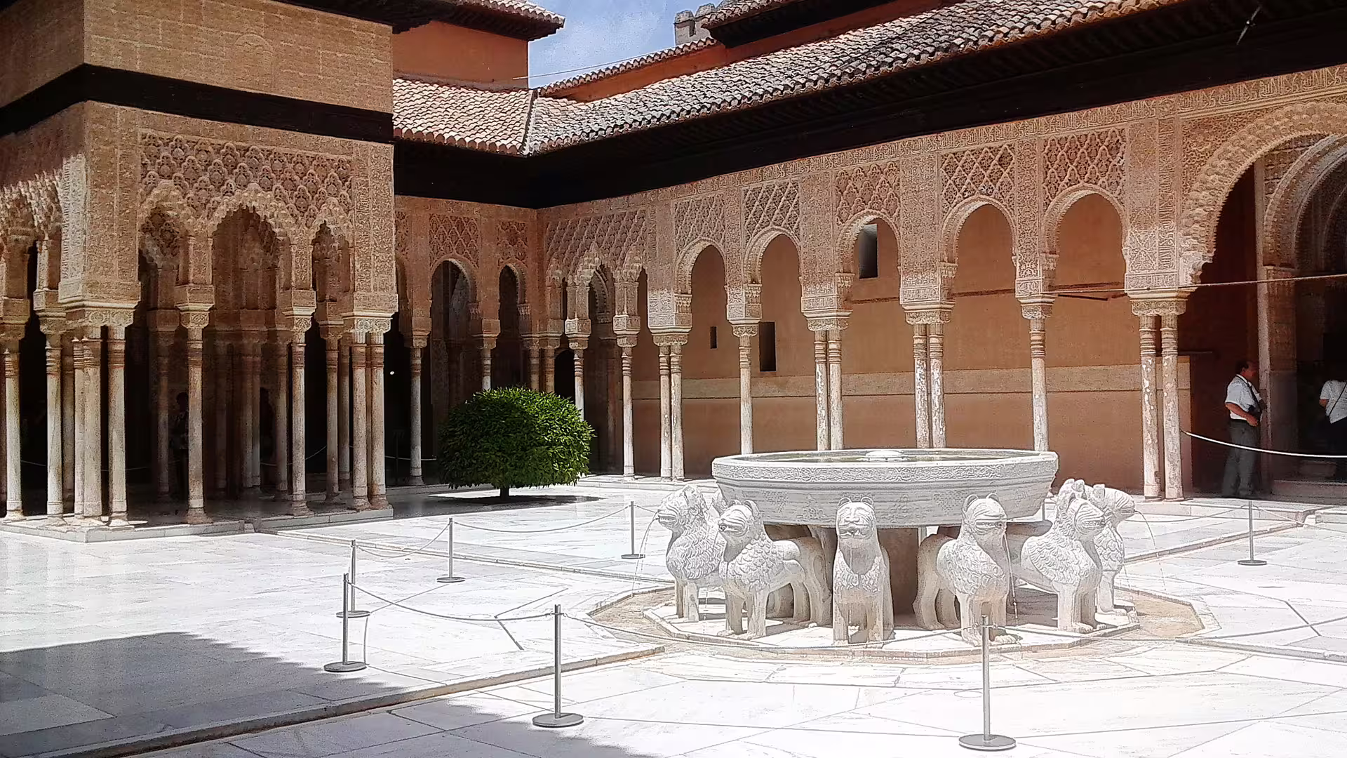 Patio of the Lions fountain and Moorish arches in the Alhambra, Granada, on a guided group walking tour
