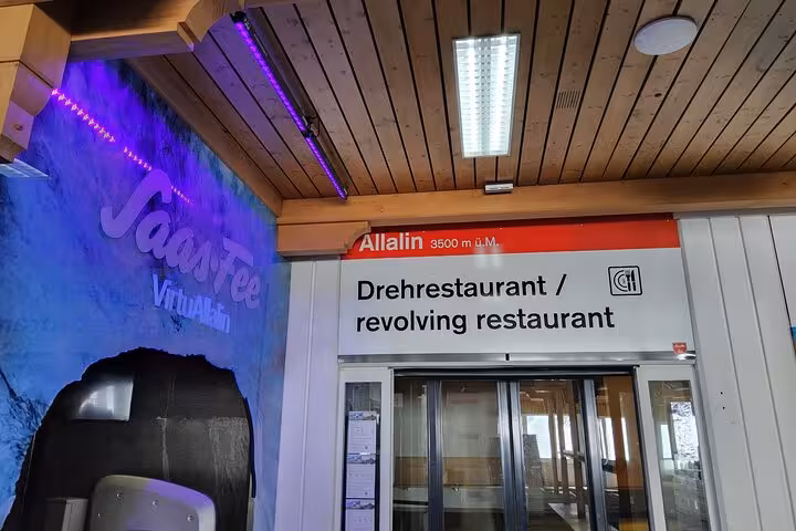 Entrance sign for Allalin 3500m revolving restaurant in Saas-Fee, a highlight of the Zurich day trip