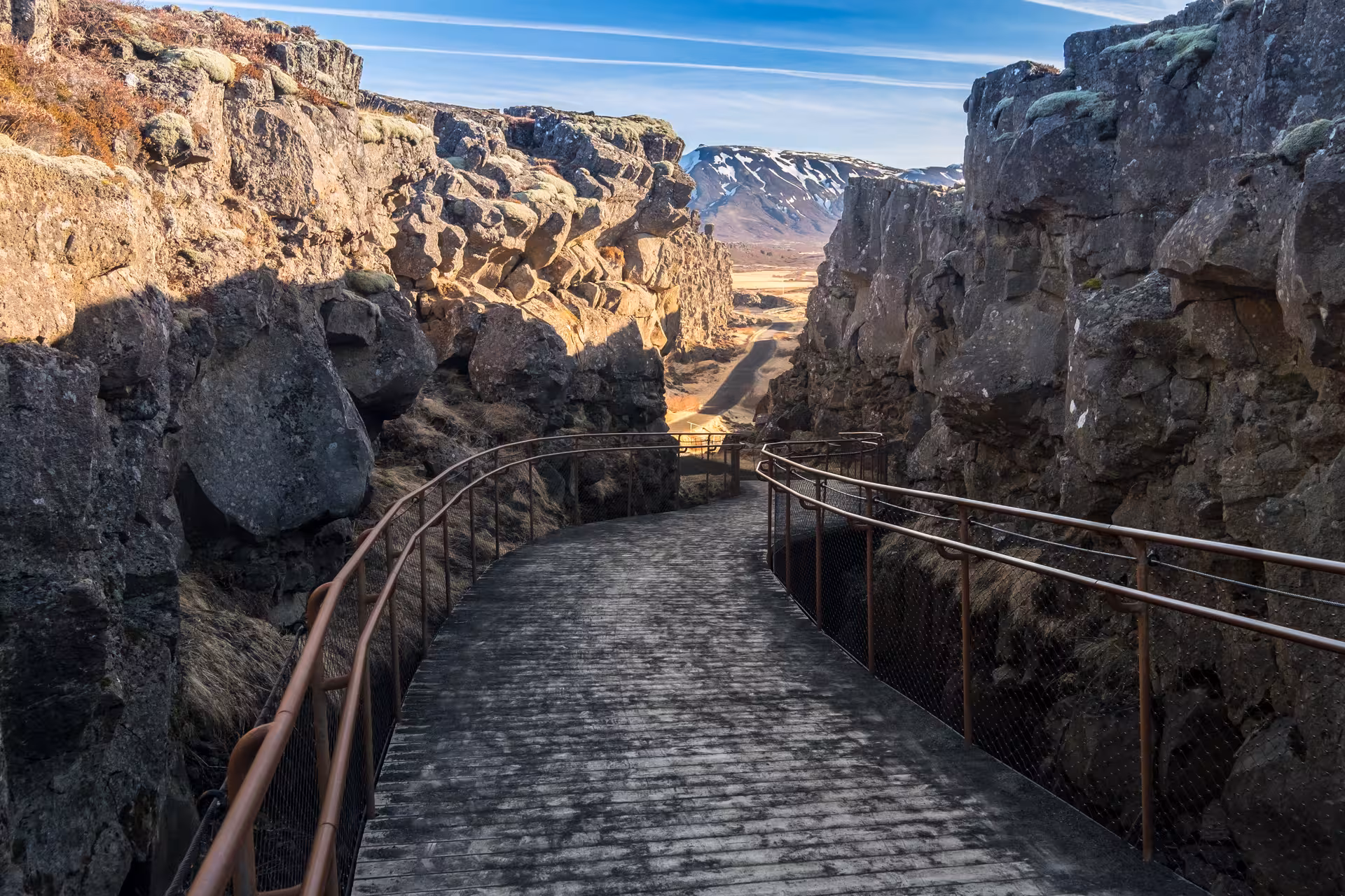 Winding path through the striking Almannagjá gorge in Þingvellir National Park, showcasing Iceland's geological wonder.