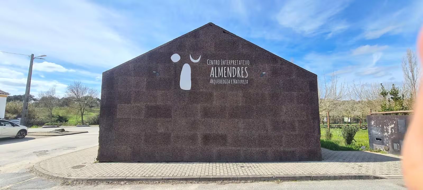 Exterior view of the Almendres Interpretive Center with clear sky in Évora, Portugal.