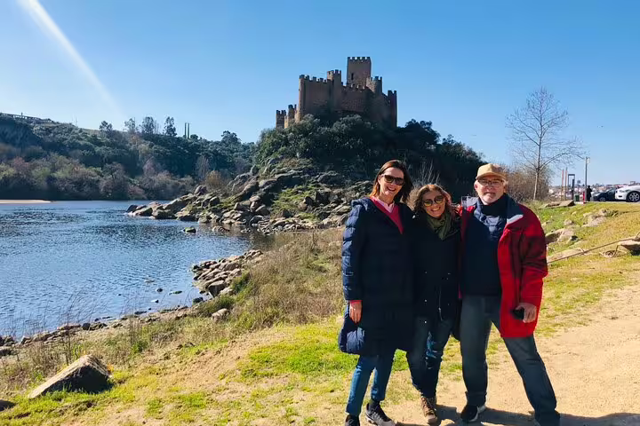 Visitors enjoying a sunny day at the historic Almourol Castle, a key site on the Tomar and Knights Templar private guided tour.
