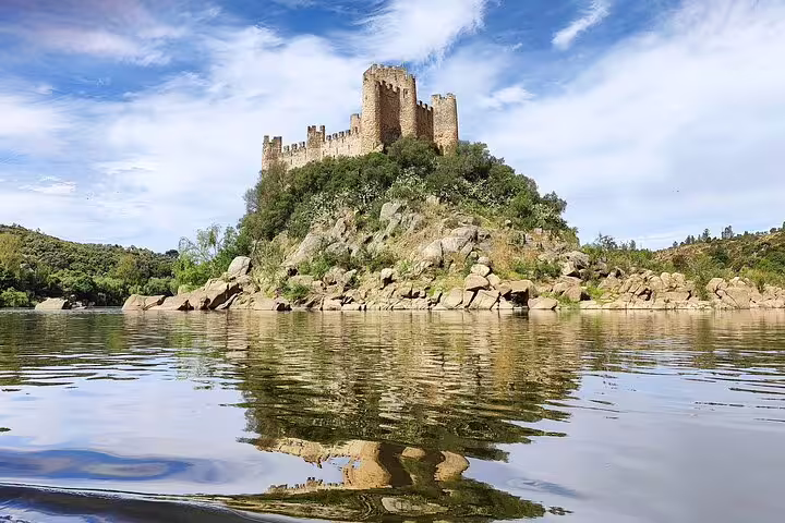 Stunning view of Almourol Castle reflecting in the river, perfect for a private day tour exploring Tomar and Templar history.