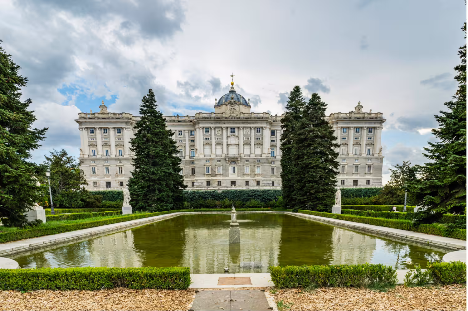 Almudena Cathedral gardens and reflecting pool near Madrid Royal Palace on a local stories walking tour
