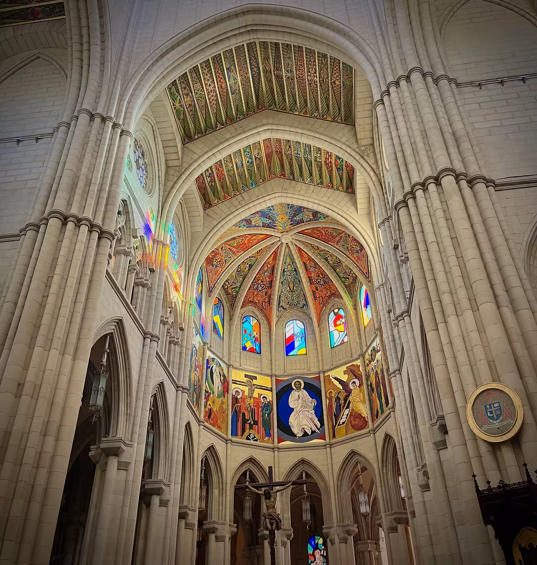 Interior of Almudena Cathedral in Madrid with stained glass and vaulted ceiling on a local history tour