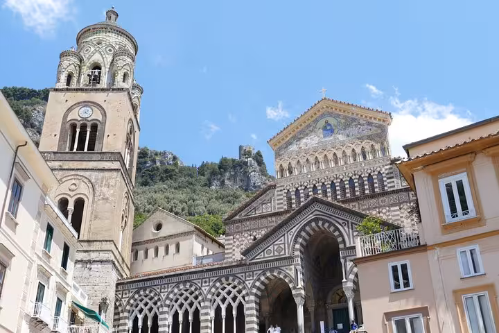Stunning view of Amalfi Cathedral's intricate architecture under a clear blue sky, perfect for cultural exploration.