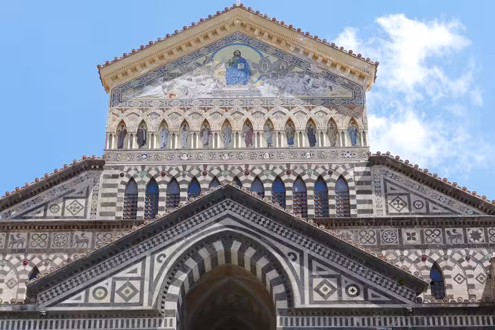 Ornate facade of Amalfi Cathedral showcasing intricate medieval mosaic and architectural details.