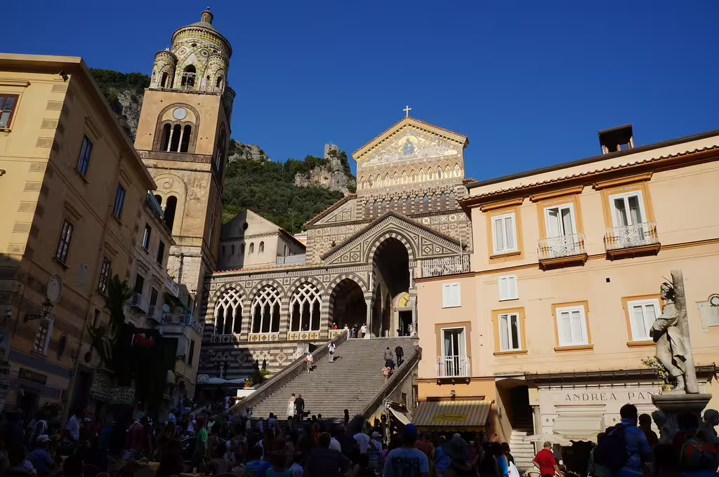 Crowds gather on the grand staircase of Amalfi Cathedral during a sunny Amalfi Coast and Ravello day tour in Italy