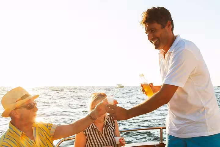 Guests enjoying drinks and sunshine on a small-group boat tour along the Amalfi Coast.