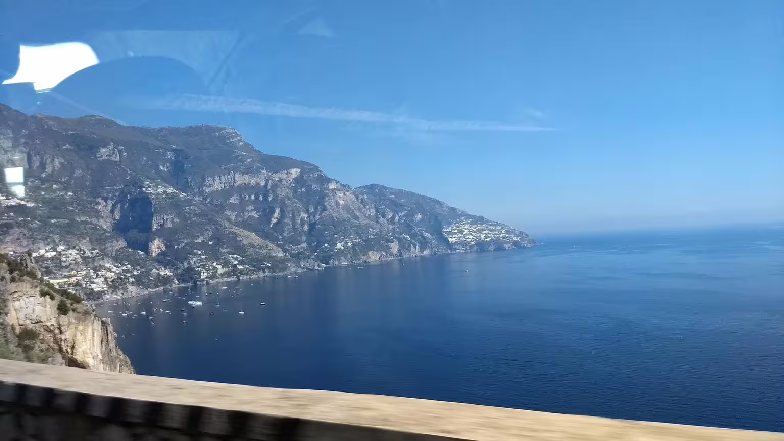 Panoramic Amalfi Coast cliffside and deep blue sea view from scenic drive on Pompeii and Amalfi Coast tour
