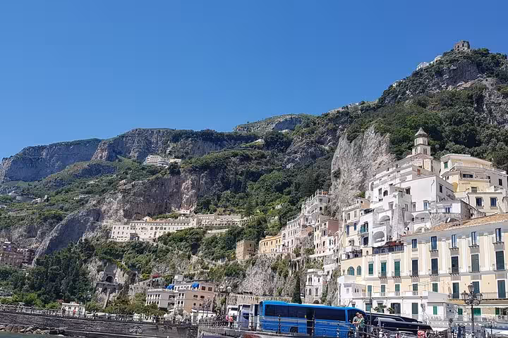 Cliffside Amalfi Coast townscape under blue sky, highlight of Rome to Sorrento and Positano full-day trip