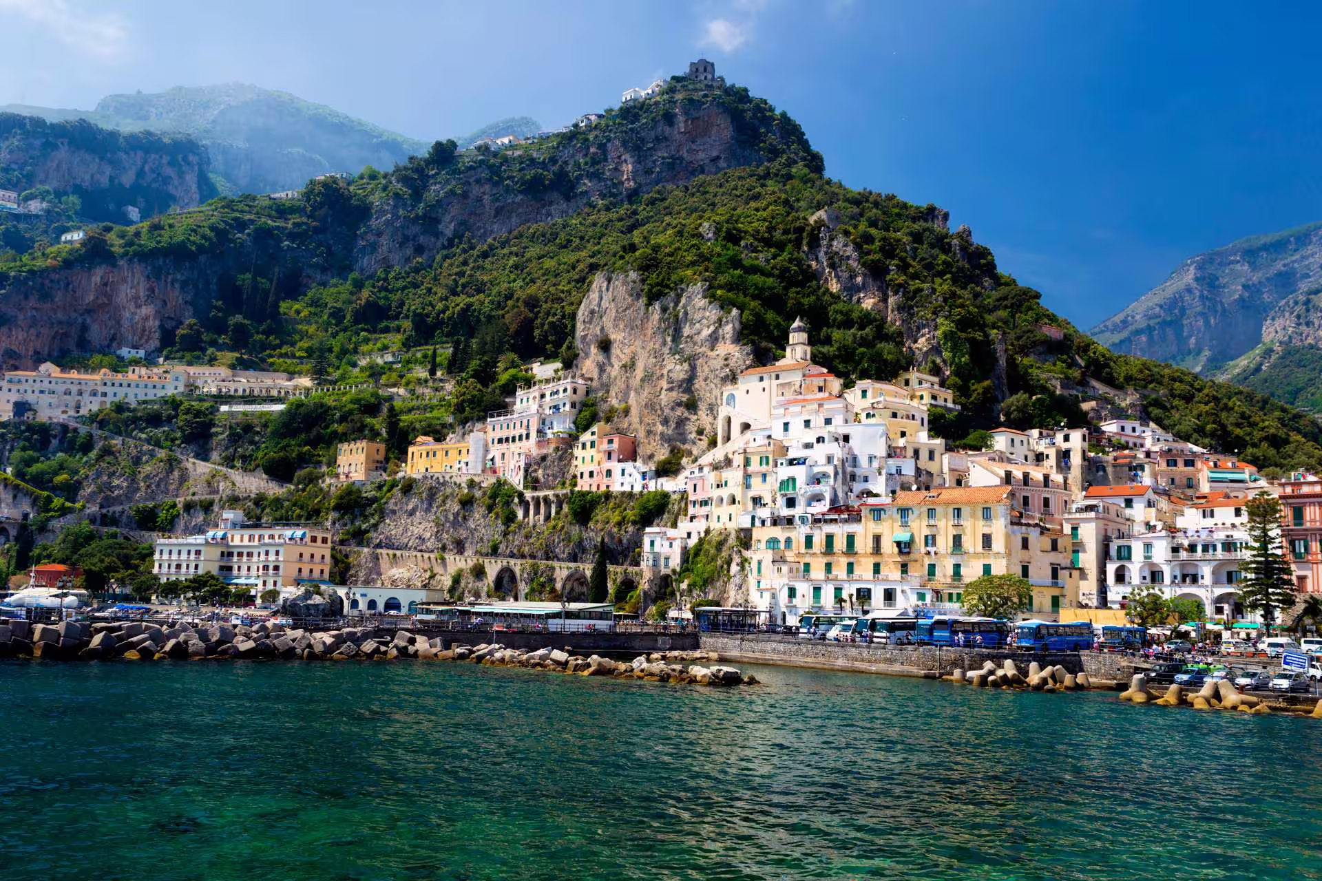 Panoramic Amalfi Coast cliffside village and turquoise sea, scenic stop on Pompeii & Amalfi from Naples low cost tour