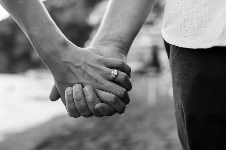 Close-up of a couple holding hands with an engagement ring, capturing a romantic moment on the Amalfi Coast tour.