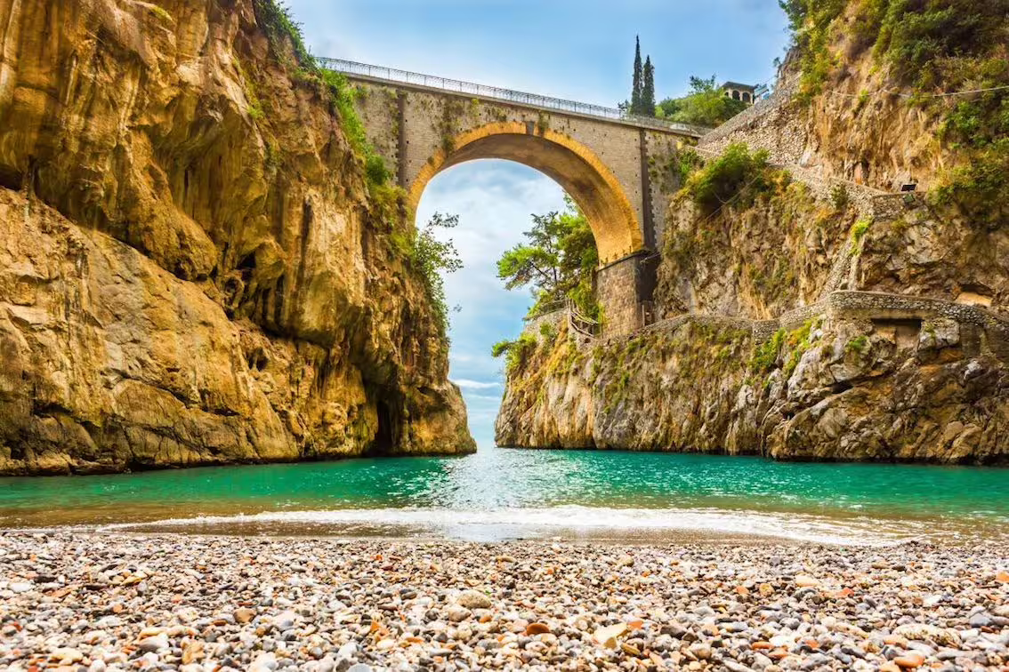 Scenic view of Fiordo di Furore's arched bridge and turquoise waters on the Amalfi Coast tour.