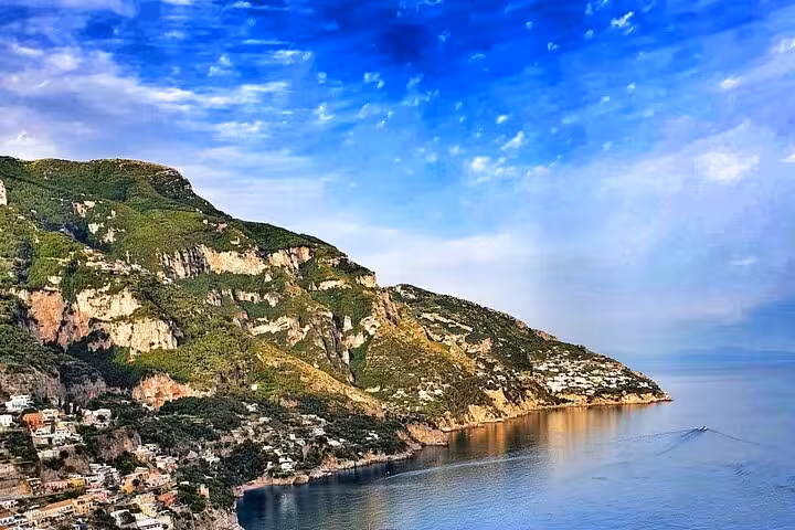Scenic view of the Amalfi Coast's rugged cliffs and serene blue waters, perfect for a full-day tour from Sorrento.