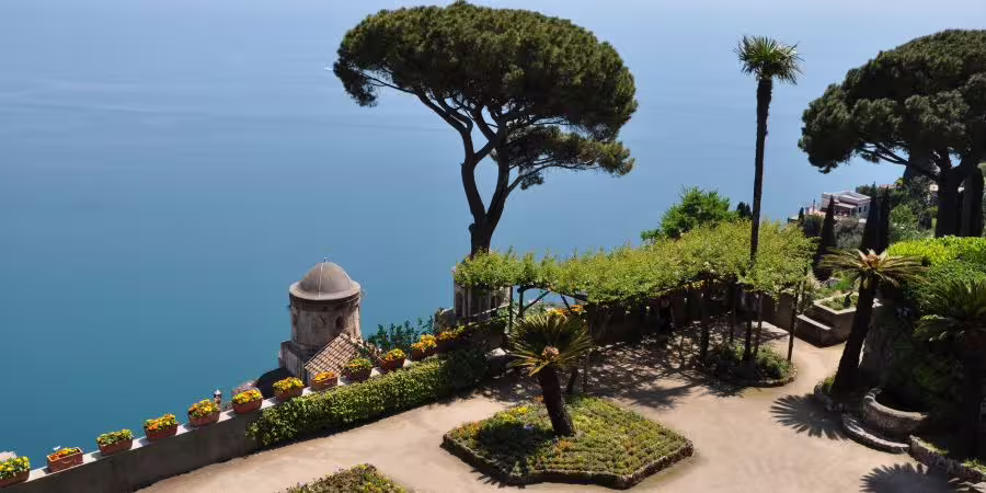 Scenic view of Amalfi coast garden with sea and lush greenery on a minivan tour.