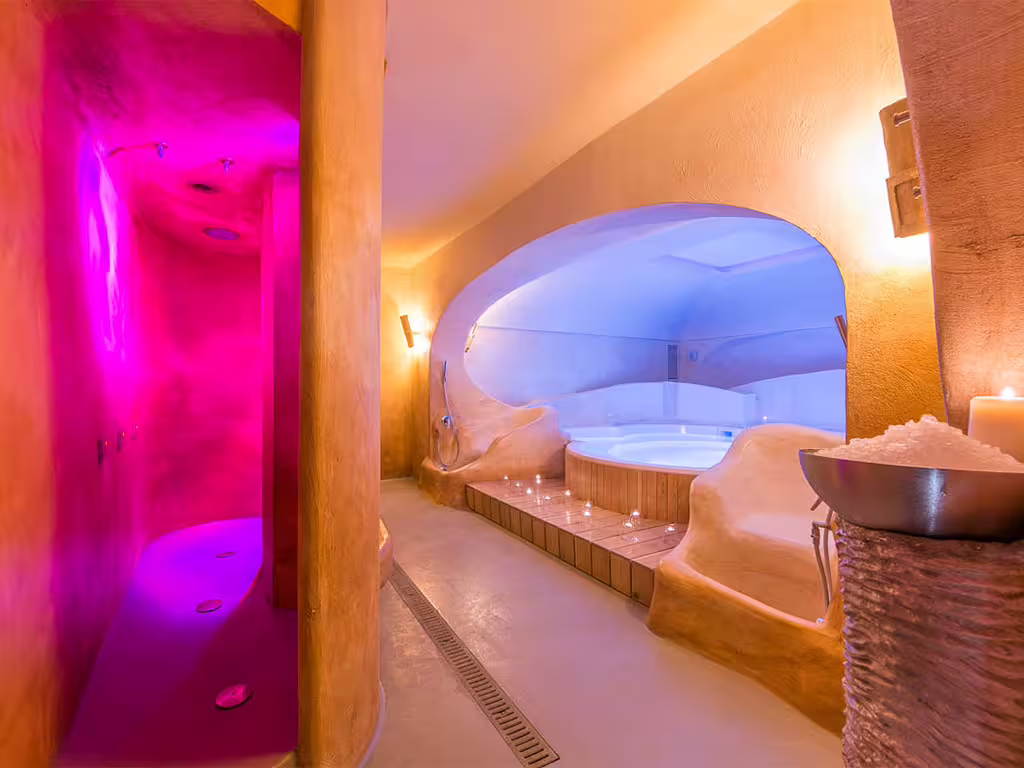 Luxurious Amalfi Coast spa suite with color therapy shower, candlelit jacuzzi and romantic wellness ambience