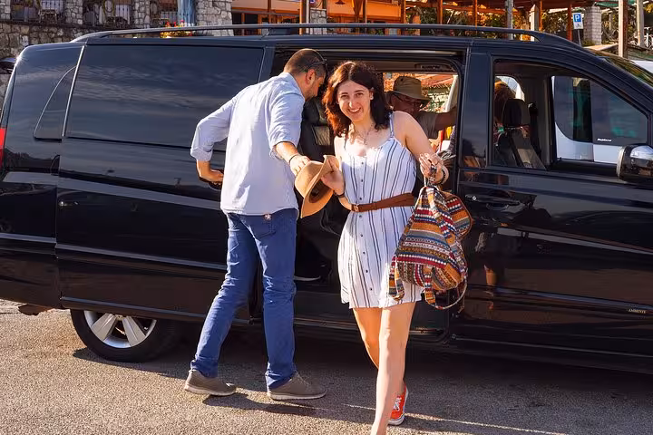 Smiling tourists board a comfortable minivan for a scenic Amalfi Coast tour departing from Sorrento.
