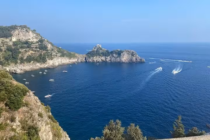Scenic view of the Amalfi Coast's rocky cliffs and azure sea, perfect for a full-day minivan tour from Sorrento.