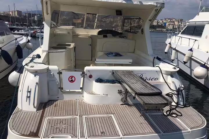 Spacious motor yacht deck with swim platform and seating, ready for a small-group Amalfi Coast boat tour from the marina