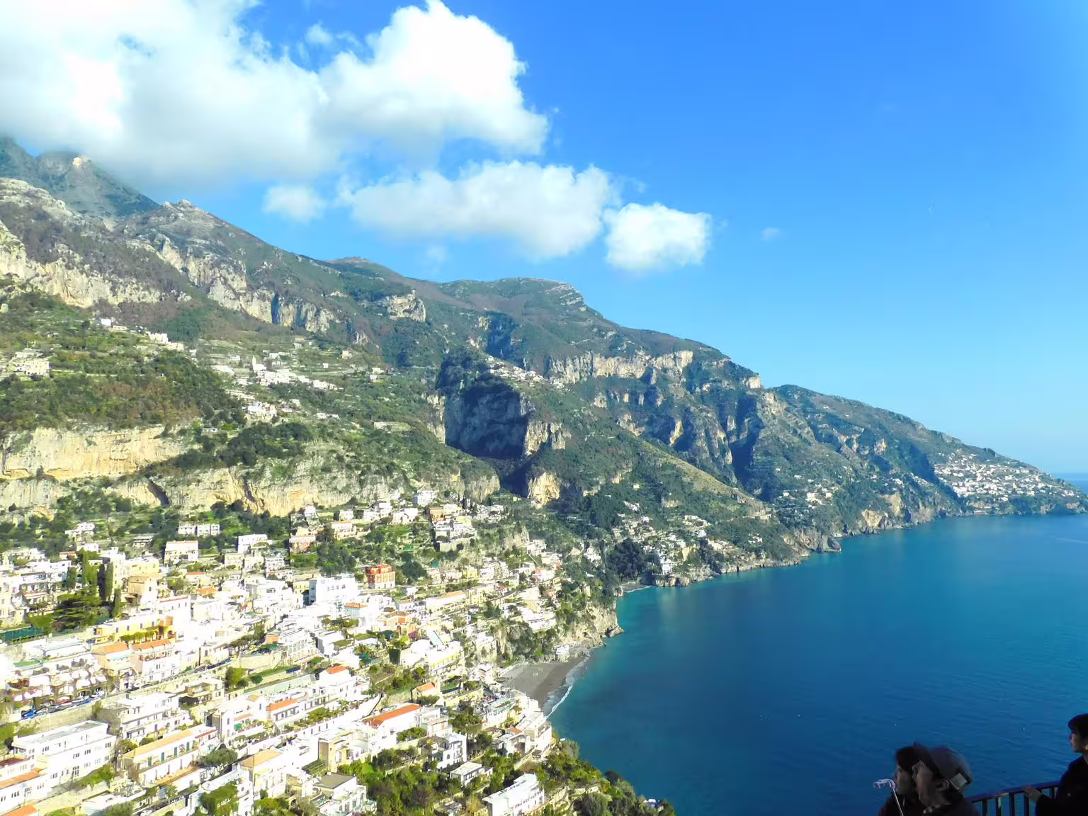 Amalfi Coast panoramic view from Naples day trip, cliffside towns and blue sea on group tour