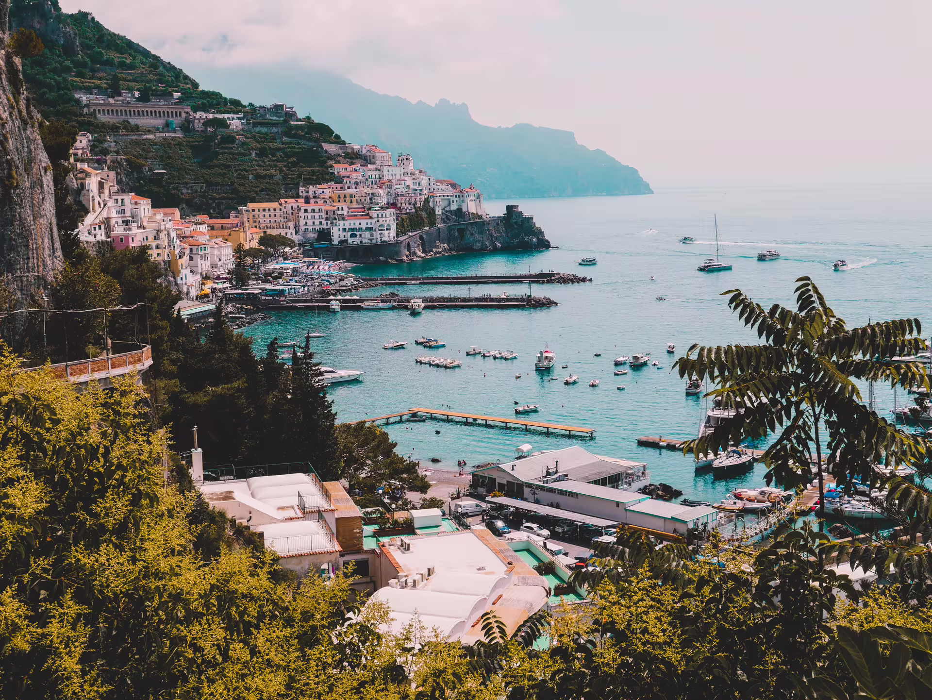 Panoramic Amalfi Coast coastline with pastel villages and boats, photo stop on Naples to Amalfi Coast tour