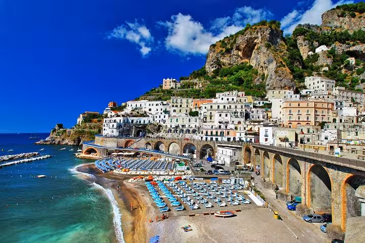 Scenic view of Amalfi Coast's vibrant beach and hillside town, ideal for Naples private shore excursions.