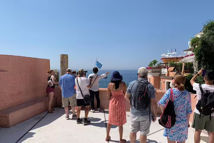 Tourists admire the stunning sea views from a lookout point in Positano on the Amalfi Coast tour.