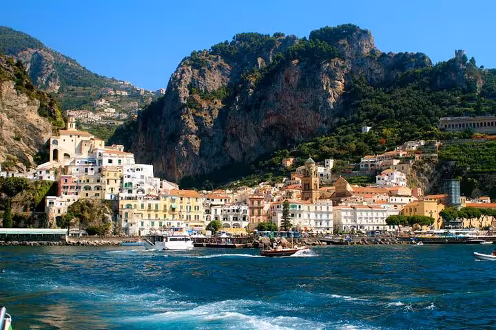 Scenic view of Amalfi Coast with colorful buildings and cliffs from a boat during a private tour.