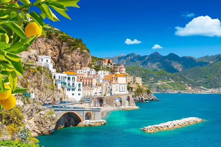 Amalfi Coast private day trip view of Amalfi town, coastal road arches and turquoise sea from Sorrento