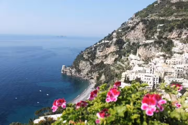 Scenic Amalfi Coast private tour view of Positano bay, cliffs and flowers overlooking the tranquil Mediterranean