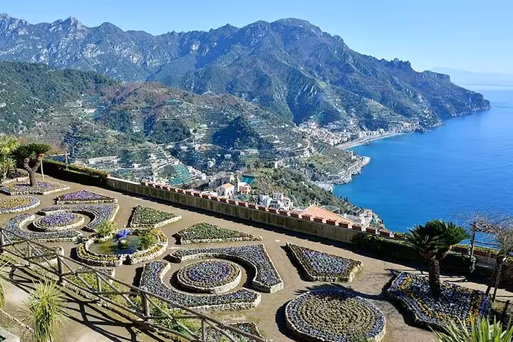Breathtaking view of the Amalfi Coast from Ravello gardens, showcasing terraced landscapes and azure Mediterranean waters.